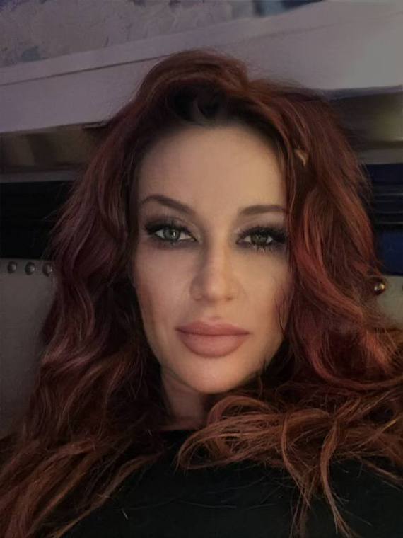 Long wavy hair colored a deep red