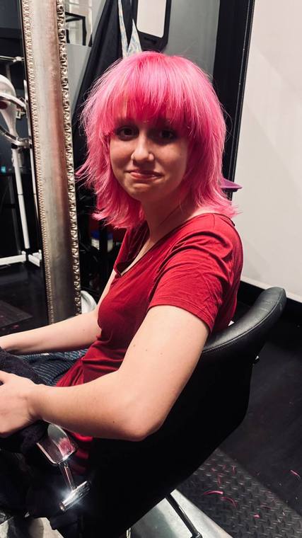 A pink shag cut with blunt bangs