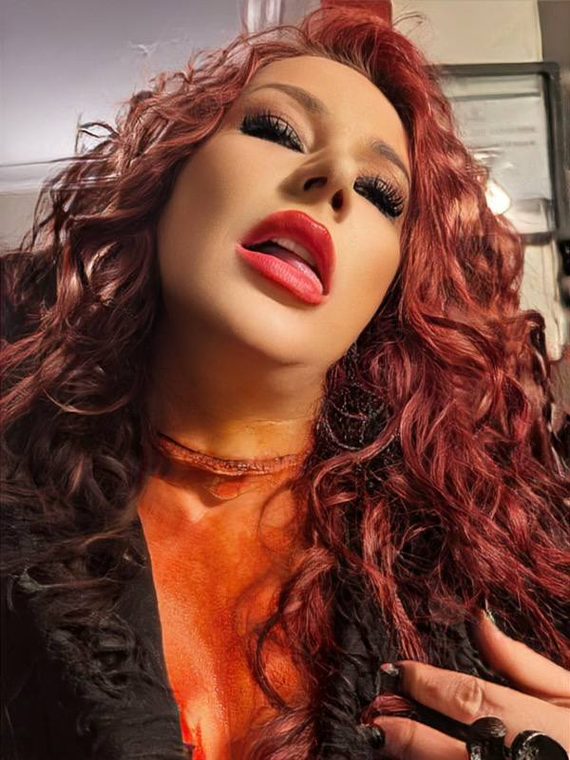 Long red curls with a deep glossy shine, styled by Christal B.