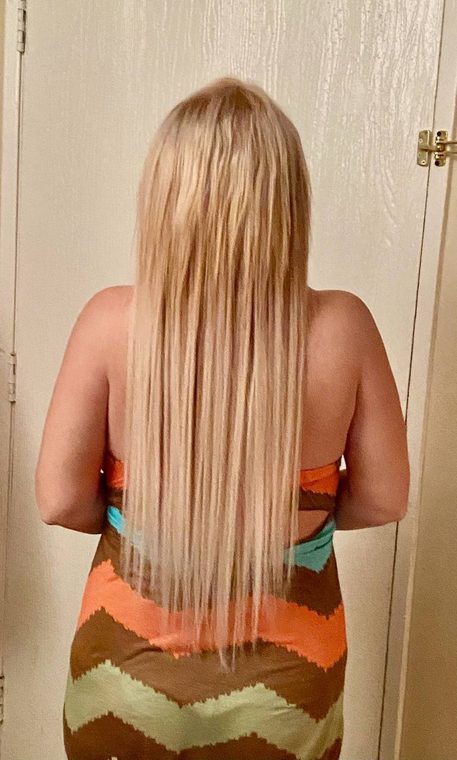 After: long blonde hair following an extension fitting by Christal B.