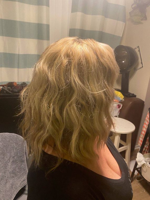 A soft blonde wave set, seen from the back, styled at Shear Lady Salon LLC