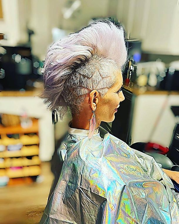 A platinum mohawk with shaved side detail, cut at Shear Lady Salon LLC