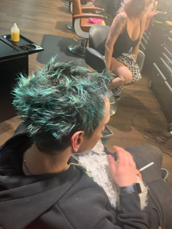 A short teal-green spiked cut, coloured at Shear Lady Salon LLC