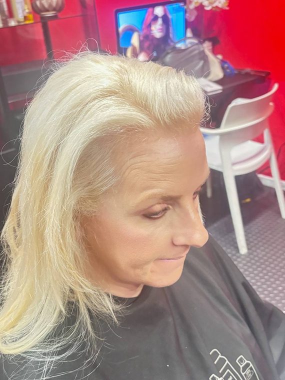 Long platinum blonde hair finished in the chair at Shear Lady Salon LLC
