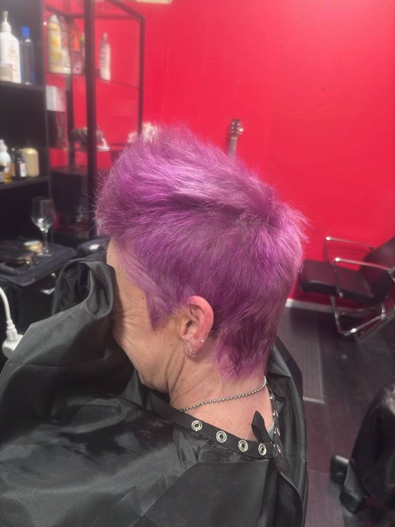 A magenta and purple pixie, seen from the back, by Christal B.