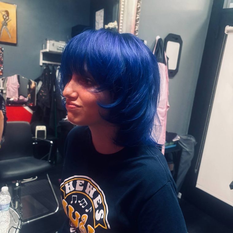 A vivid blue bob with a full fringe, coloured at Shear Lady Salon LLC