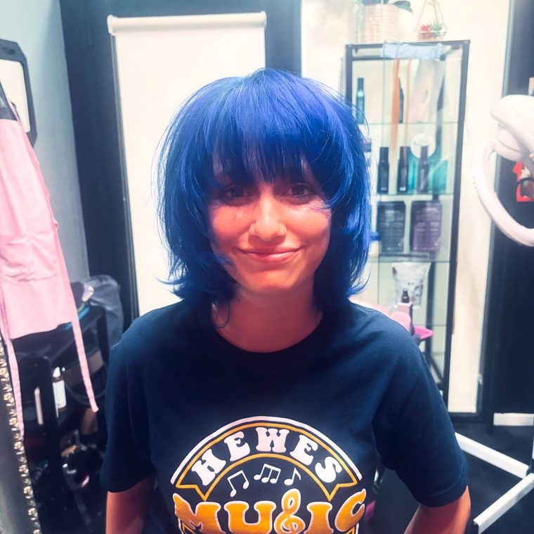A blue shag with a feathered fringe, coloured at Shear Lady Salon LLC