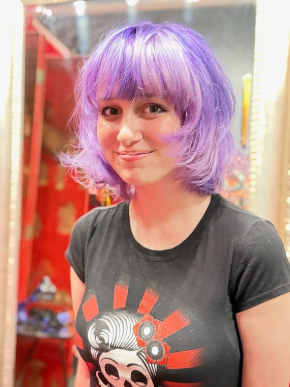 A purple bob with a blunt fringe, coloured at Shear Lady Salon LLC